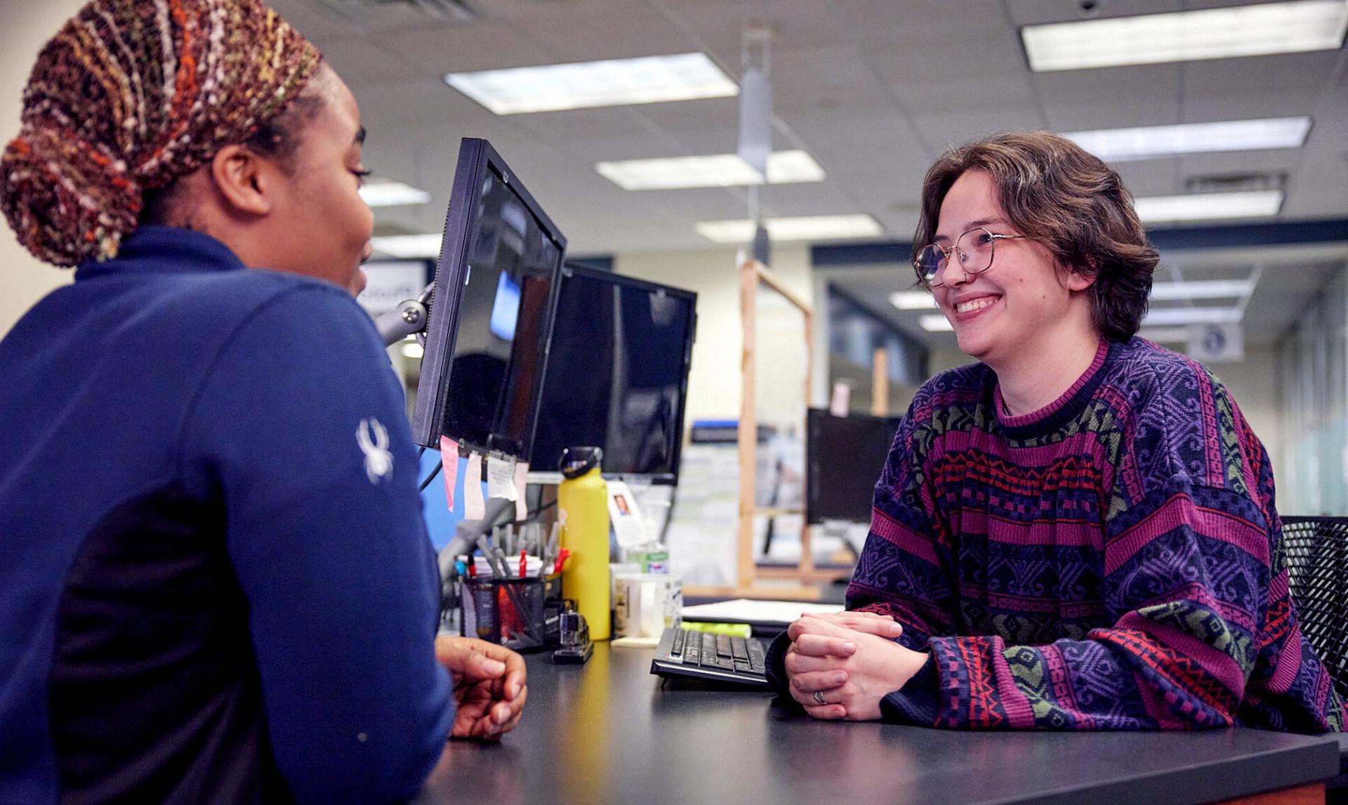 Staff and student in Admissions Office.